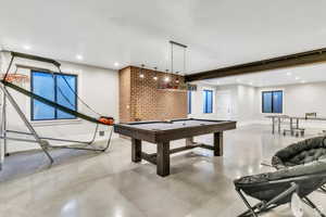 offering the perfect setup for pool, games, and gathering with friends and family. Seamlessly connected to the lower-level amenities, this space enhances the home’s ultimate entertainment experience.