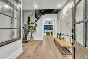 Thoughtfully designed entryway featuring a custom staircase with handcrafted metalwork by a local artist