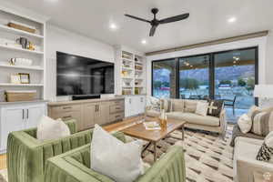 The heart of the home, this beautifully designed living room offers effortless flow into the kitchen and is perfect for gathering and entertaining. Floor-to-ceiling windows capture breathtaking mountain views and open to a covered deck, creating a true in
