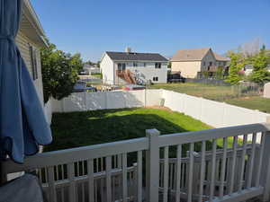 Fenced backyard with a residential view and stairs
