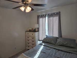 Bedroom with ceiling fan and baseboards