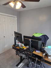 Office space with a ceiling fan and carpet flooring