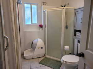 Bathroom featuring a stall shower and light tile patterned flooring