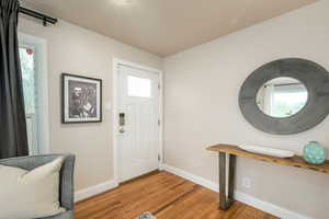 Entryway featuring baseboards and light wood-type flooring