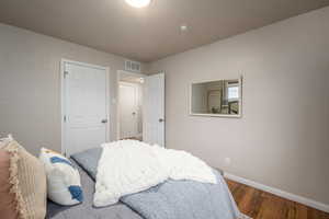 Bedroom featuring baseboards and wood finished floors