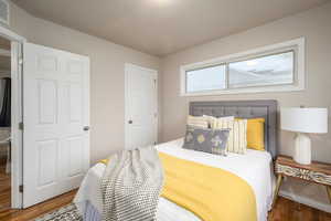 Bedroom featuring wood finished floors and baseboards