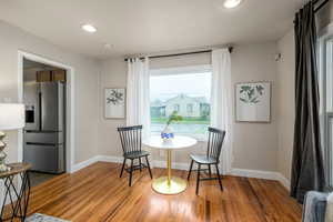 Dining area with recessed lighting and light wood finished floors