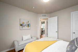 Bedroom with wood finished floors and baseboards