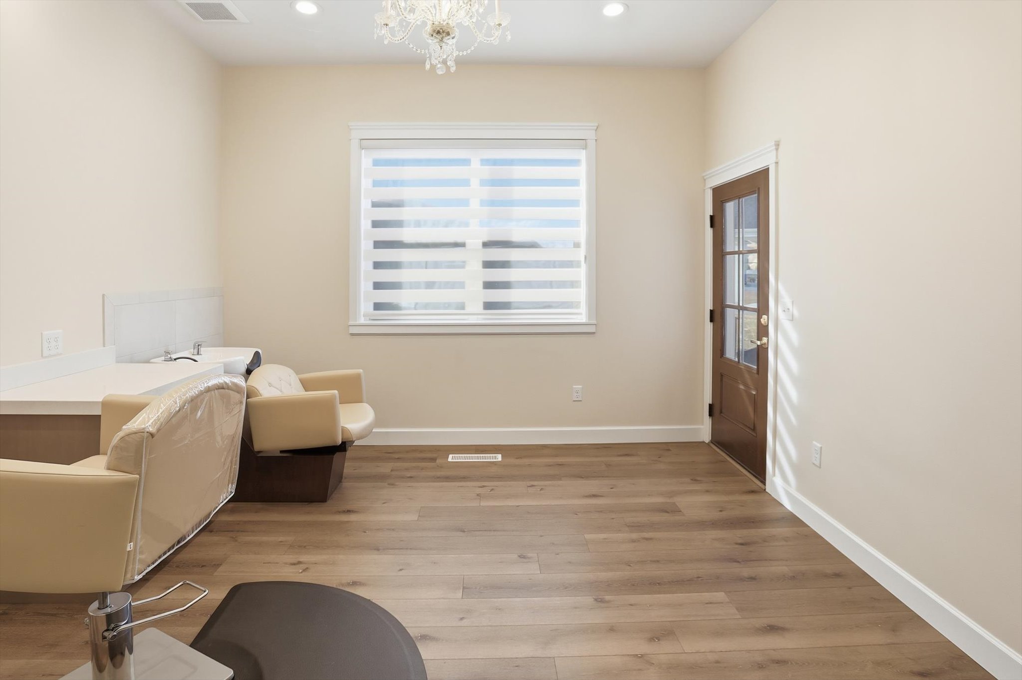 Sitting room featuring hanging lights and light wood-style flooring