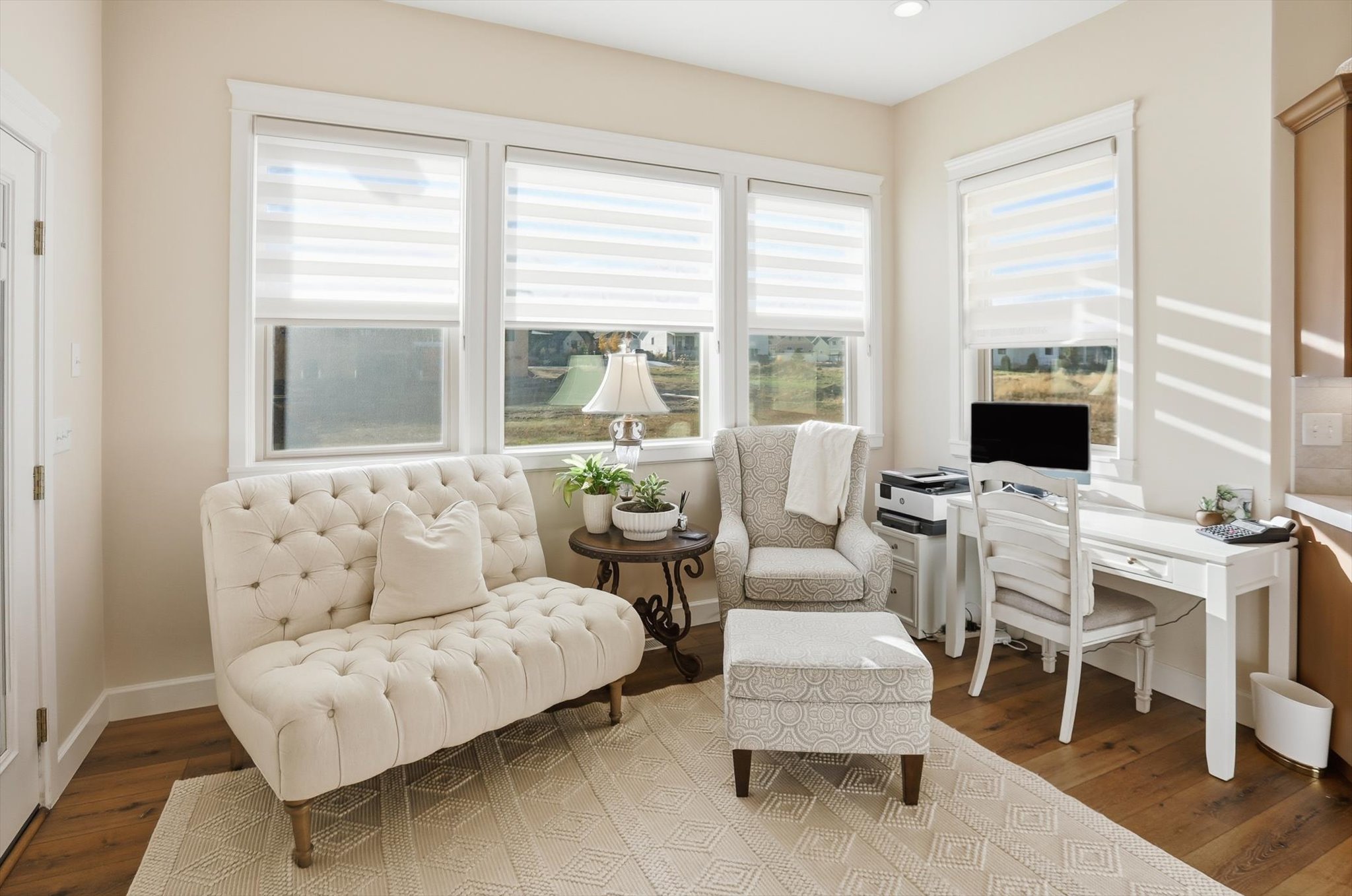 Living area featuring an office area, plenty of natural light, and wood finished floors