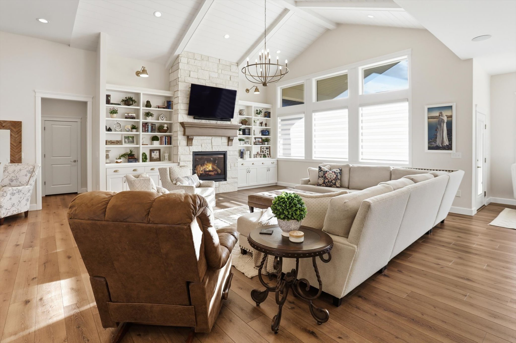 Living room featuring hardwood / wood-style floors, a chandelier, and a fireplace