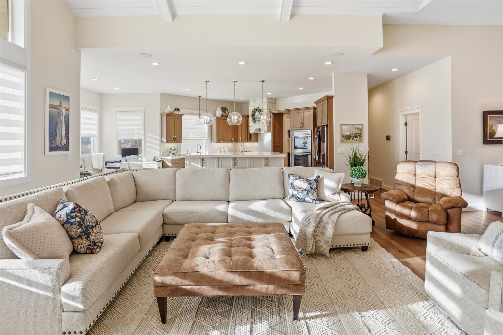 Living area with light wood-style floors and recessed lighting
