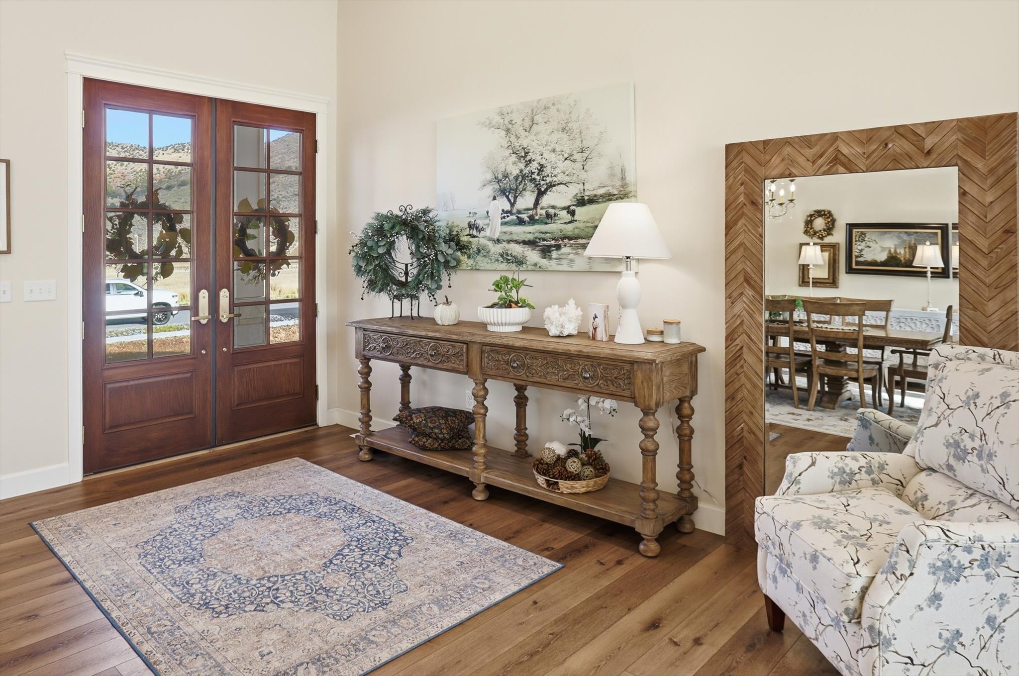 Entryway featuring french doors, wood-type flooring, and suspended lighting