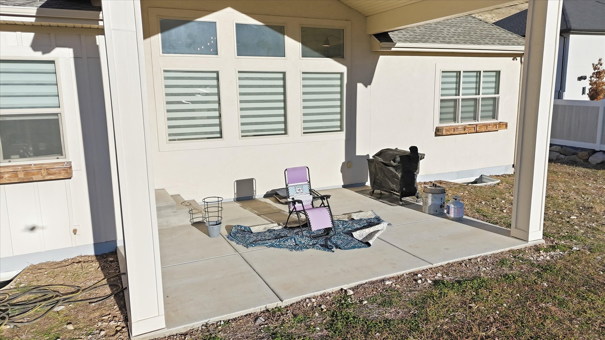 View of patio with a grill