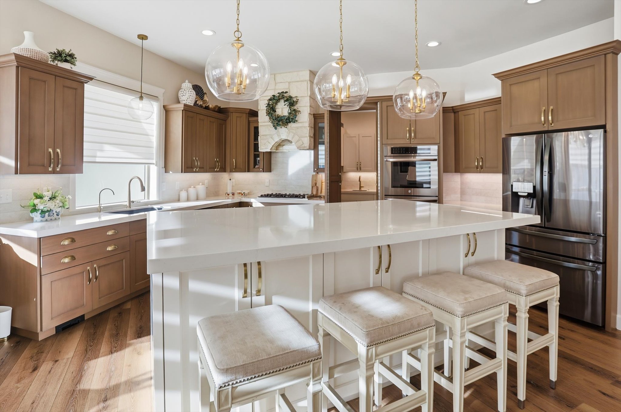 Kitchen featuring decorative backsplash, stainless steel appliances, a kitchen island, a kitchen bar, and dual tone cabinets
