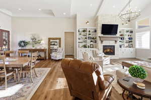 Living room with plenty of natural light, hardwood / wood-style flooring, and a high ceiling