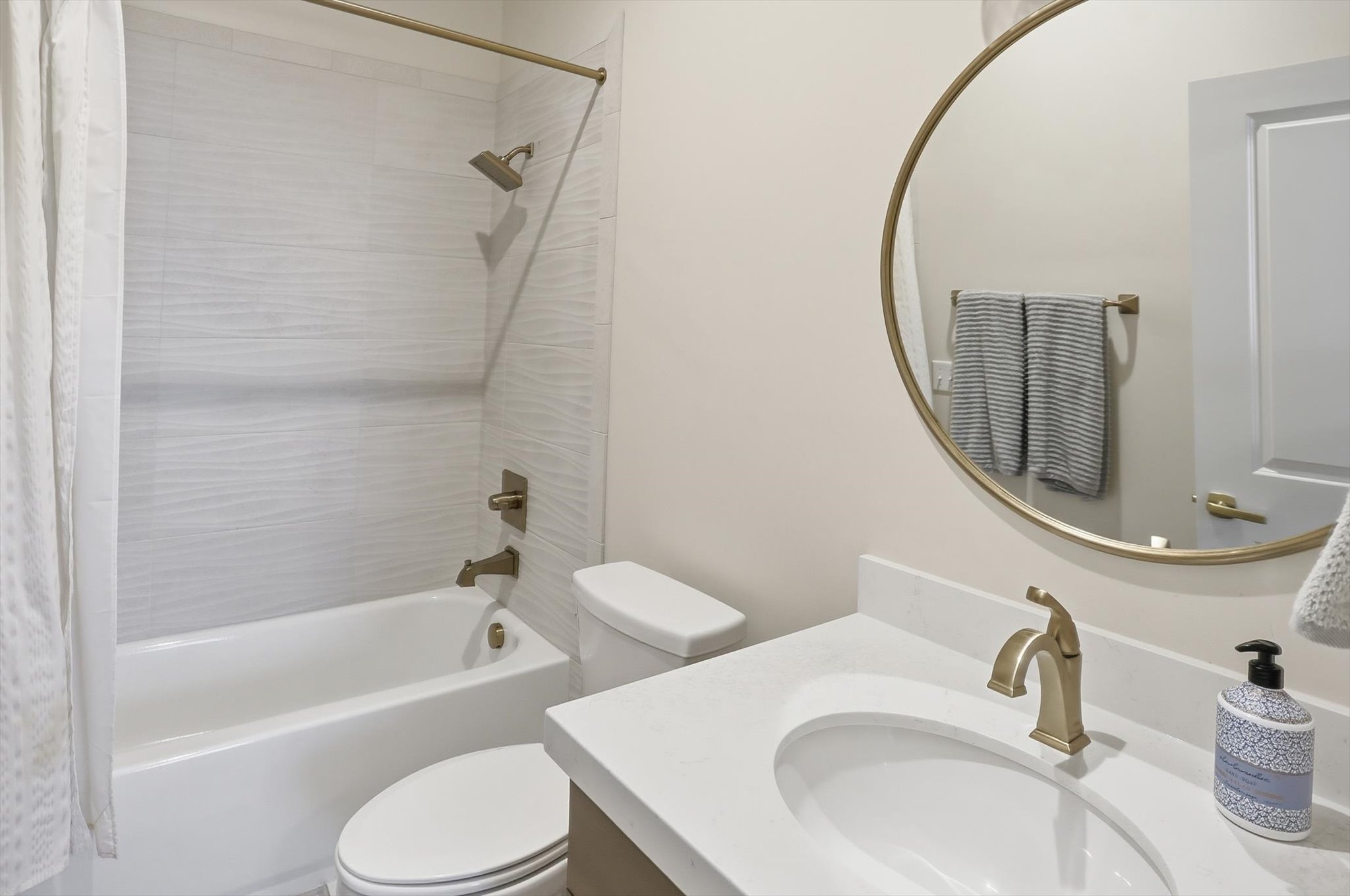 Bathroom featuring vanity and shower / tub combo with curtain