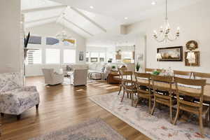Dining area with hanging lights and light wood-style floors
