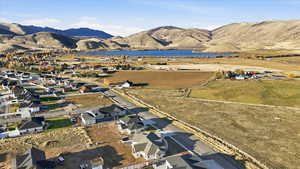 Aerial view of property's location featuring a water and mountain view and nearby suburban area