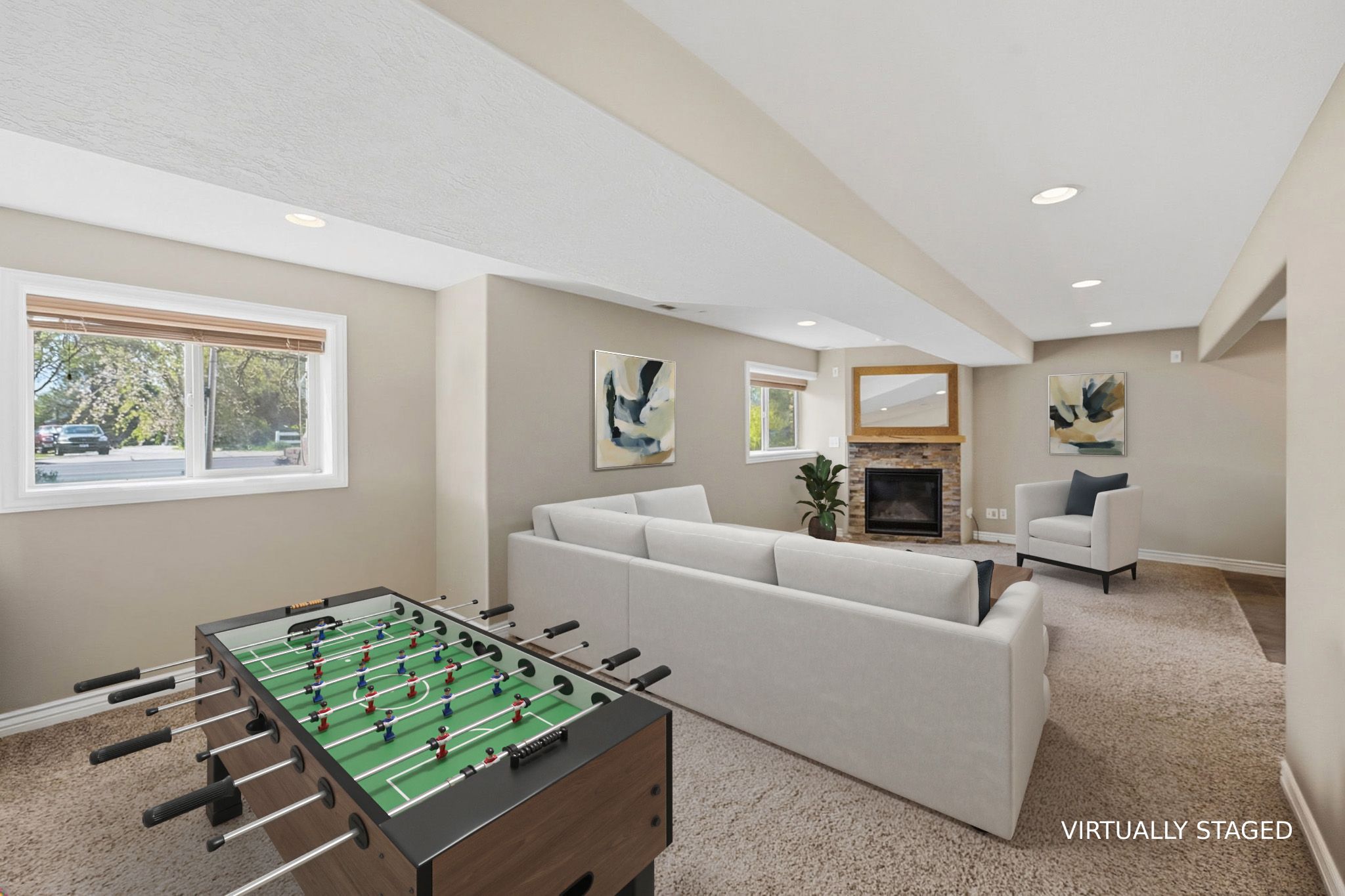 STAGED recreation room featuring stone fireplace, carpet flooring, and recessed lighting