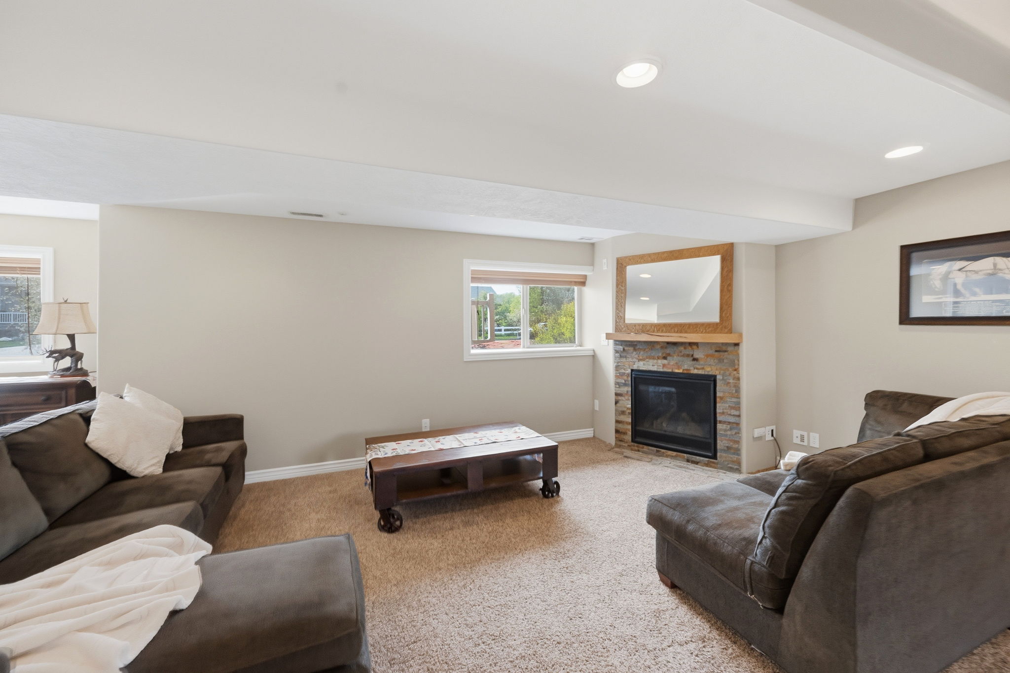 Carpeted living area with a fireplace and recessed lighting