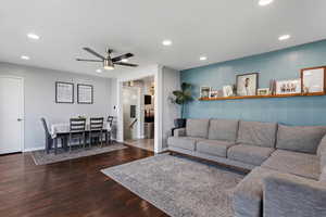 Living room featuring recessed lighting, a ceiling fan, and dark wood-style floors