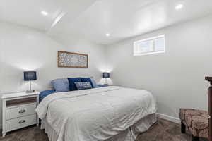 Bedroom with dark carpet and recessed lighting