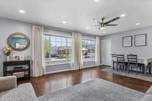 Dining space with dark wood-type flooring, a ceiling fan, plenty of natural light, and recessed lighting