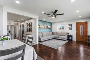 Living area with a ceiling fan, dark wood finished floors, and recessed lighting
