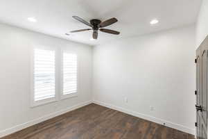 Spare room featuring dark wood-style flooring, ceiling fan, and recessed lighting