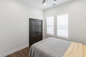Bedroom with dark wood finished floors, ceiling fan, a closet, and recessed lighting