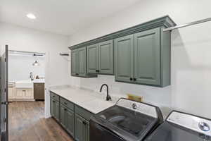 Laundry area featuring cabinet space, dark wood-style flooring, recessed lighting, and washing machine and dryer