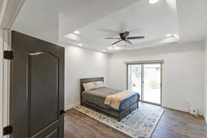 Bedroom featuring recessed lighting, access to outside, dark wood finished floors, a raised ceiling, and ceiling fan