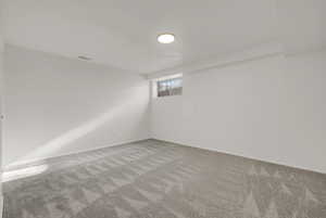 Below grade area featuring carpet and baseboards