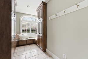 Mudroom with baseboards and light tile patterned floors
