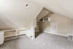 Bonus room featuring light carpet and baseboards