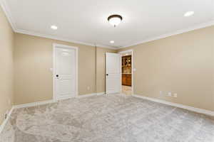 Unfurnished bedroom with light colored carpet, recessed lighting, and ornamental molding