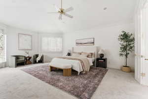 Carpeted bedroom with lofted ceiling, a ceiling fan, crown molding, and recessed lighting