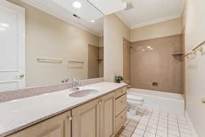 Full bathroom with vanity, light tile patterned floors, crown molding, shower / washtub combination, and recessed lighting