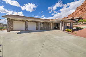 View of front of property with an attached garage, concrete driveway, and brick siding