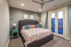 Bedroom with french doors, an accent wall, access to outside, recessed lighting, and carpet flooring