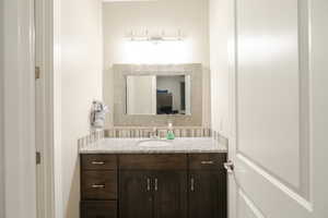 Bathroom with vanity and tasteful backsplash