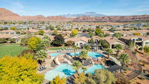 Aerial view of residential area with a mountainous background and a pool