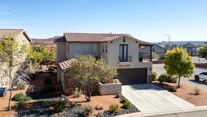 Mediterranean / spanish-style house featuring a balcony, an attached garage, stucco siding, concrete driveway, and a tile roof