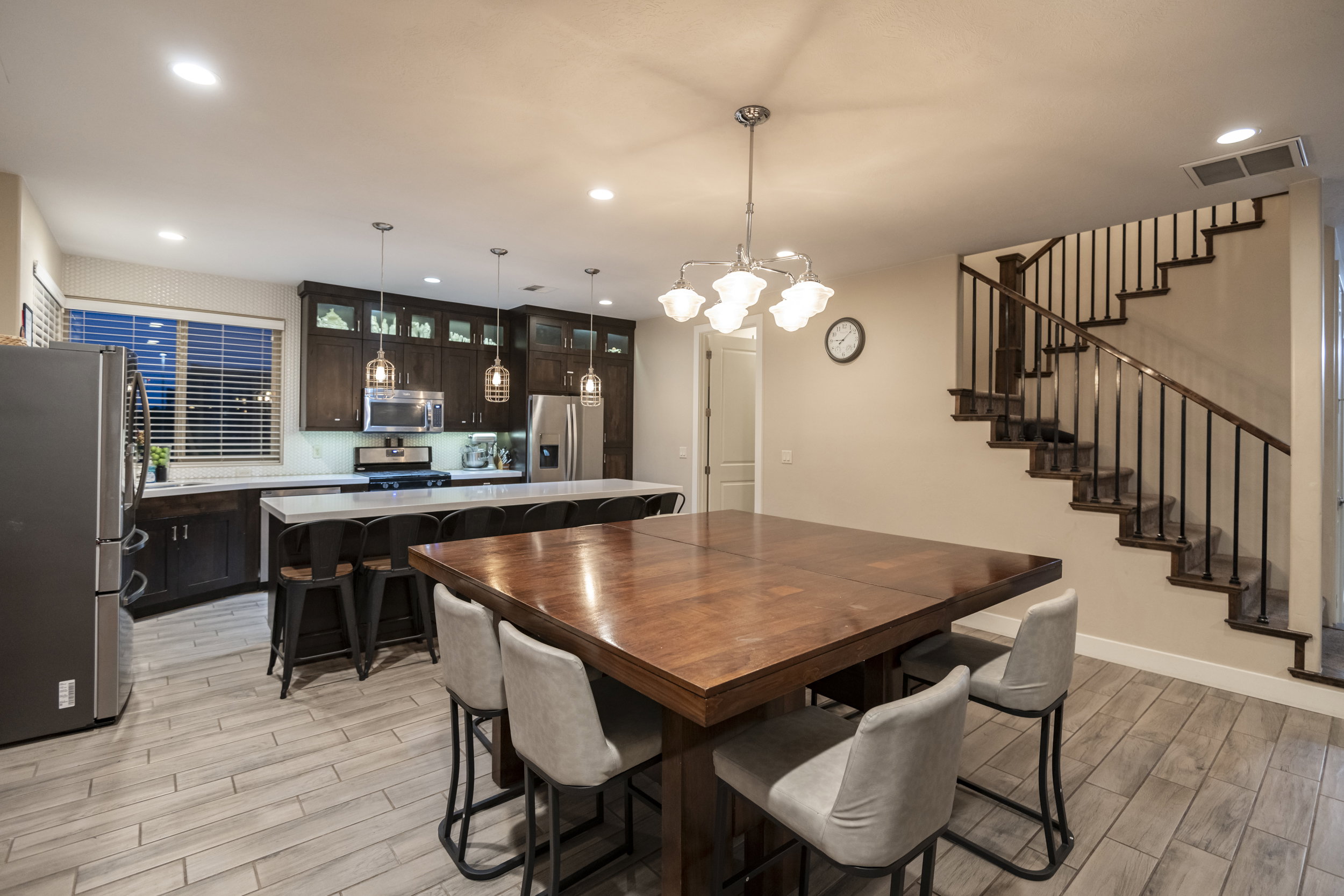 Dining space featuring wood tiled floors and hanging lights