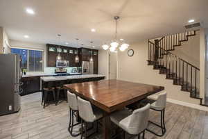 Dining space featuring wood tiled floors and hanging lights