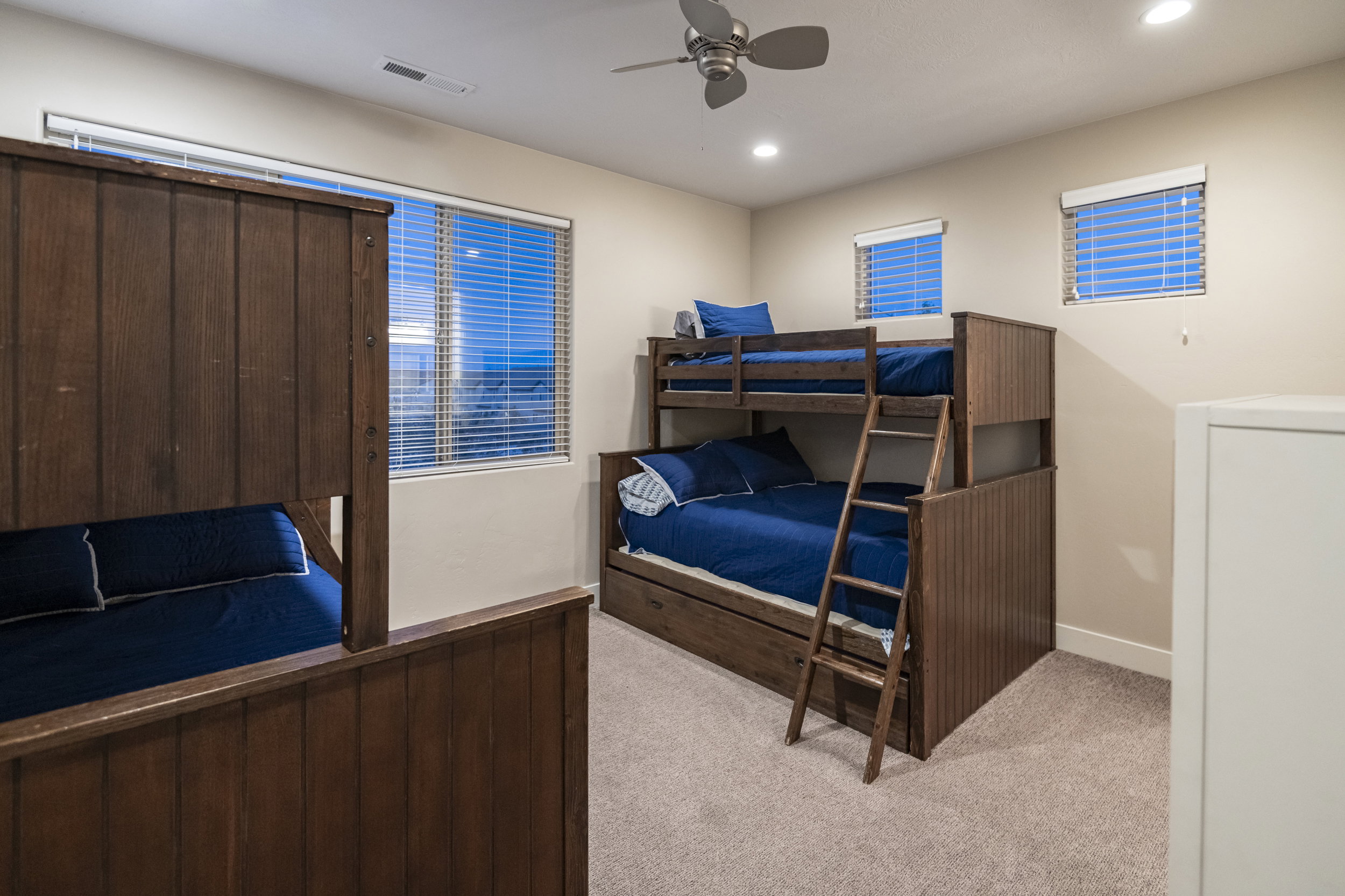 Bedroom with light carpet, a ceiling fan, and recessed lighting
