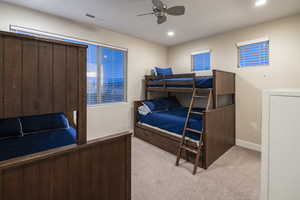 Bedroom with light carpet, a ceiling fan, and recessed lighting