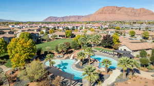 Aerial perspective of suburban area with mountains and a pool