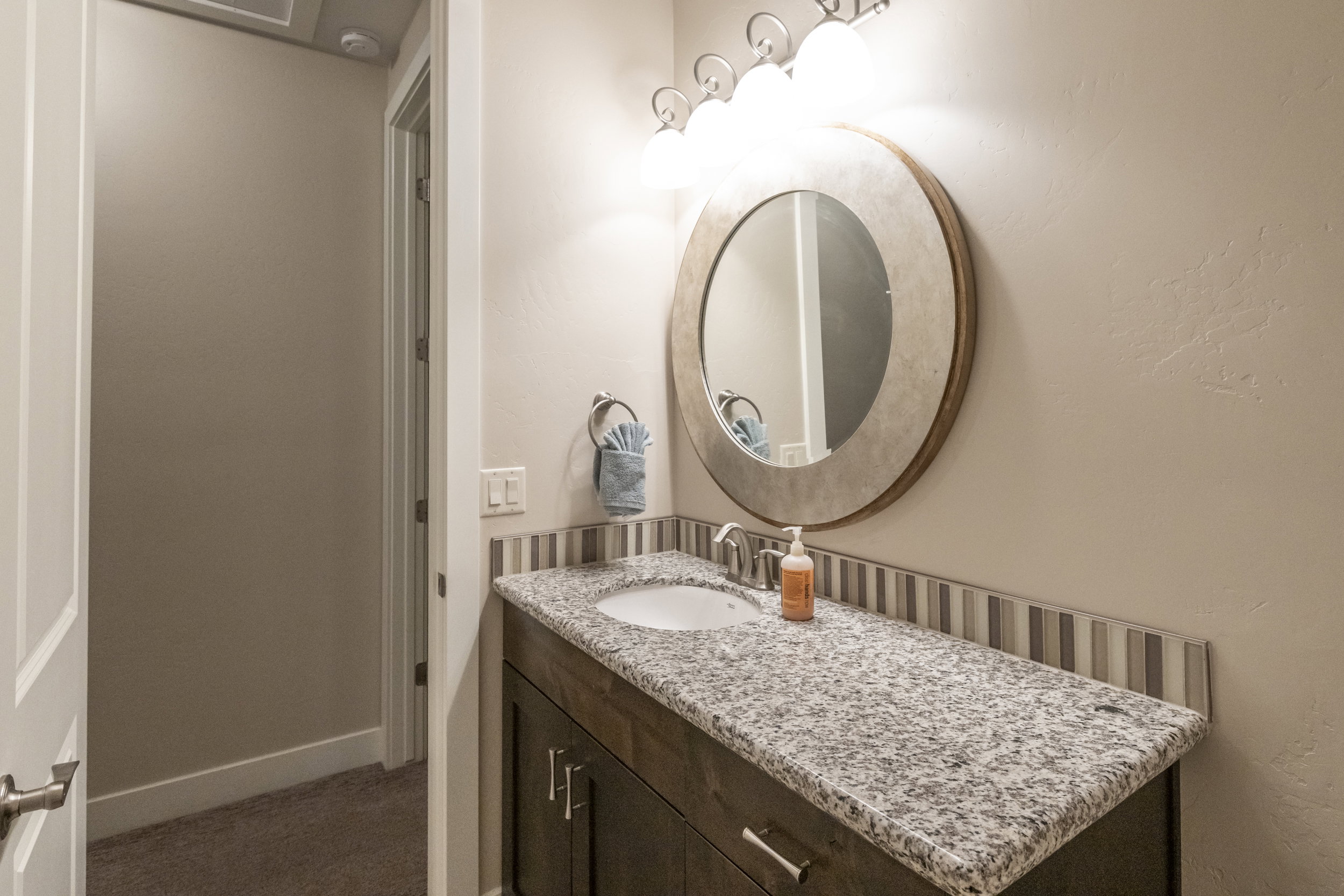 Bathroom featuring vanity and a textured wall